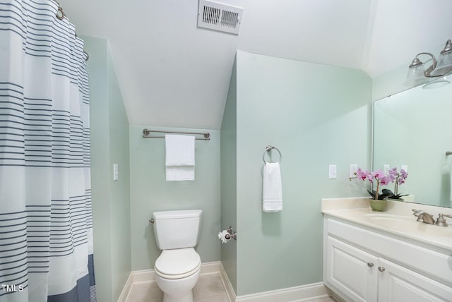8840 Woodyhill Rd, Raleigh, NC 27613 - bathroom with vanity, vaulted ceiling, toilet, baseboards, and tile patterned flooring