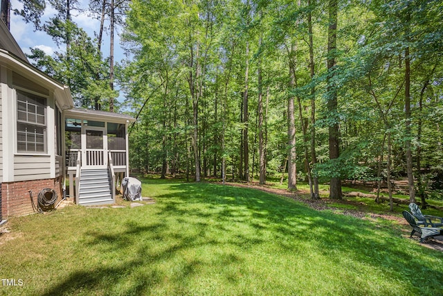 8840 Woodyhill Rd, Raleigh, NC 27613 - view of grassy yard with a sunroom