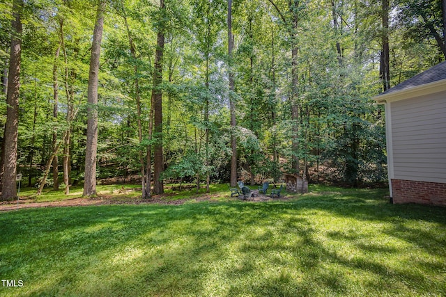 8840 Woodyhill Rd, Raleigh, NC 27613 - view of green lawn featuring a forest view