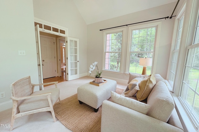8840 Woodyhill Rd, Raleigh, NC 27613 - carpeted living room featuring french doors and high vaulted ceiling