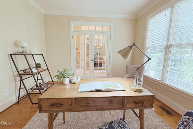 8840 Woodyhill Rd, Raleigh, NC 27613 - office area featuring wood finished floors, ornamental molding, and french doors