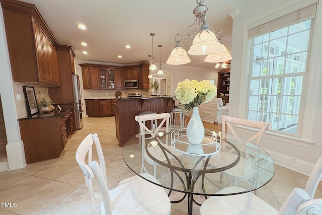 8840 Woodyhill Rd, Raleigh, NC 27613 - dining area with recessed lighting, light tile patterned flooring, and crown molding
