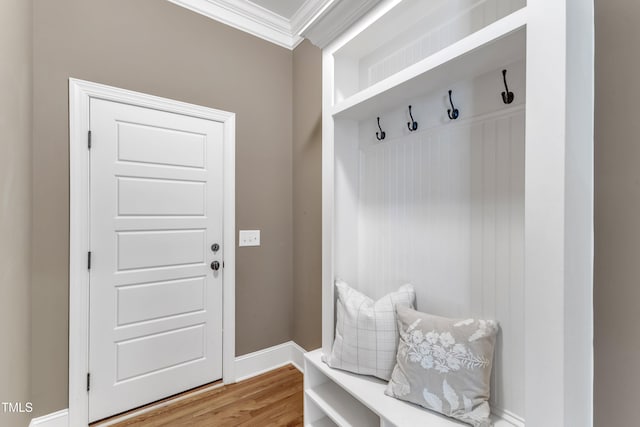mudroom with ornamental molding and light wood finished floors