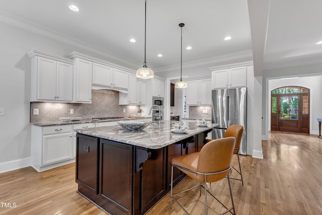 kitchen featuring baseboards, white cabinetry, crown molding, and stainless steel appliances