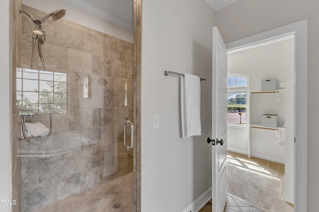bathroom with crown molding, baseboards, and a stall shower