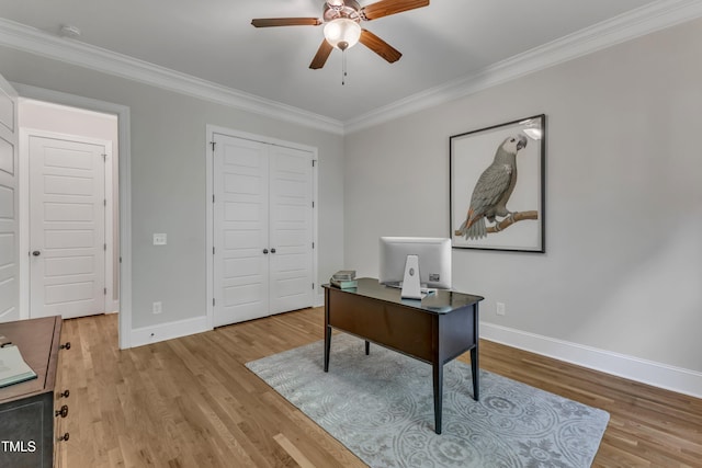home office with crown molding, baseboards, a ceiling fan, and wood finished floors