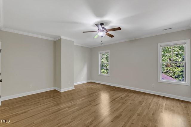 spare room featuring baseboards, a ceiling fan, wood finished floors, and visible vents