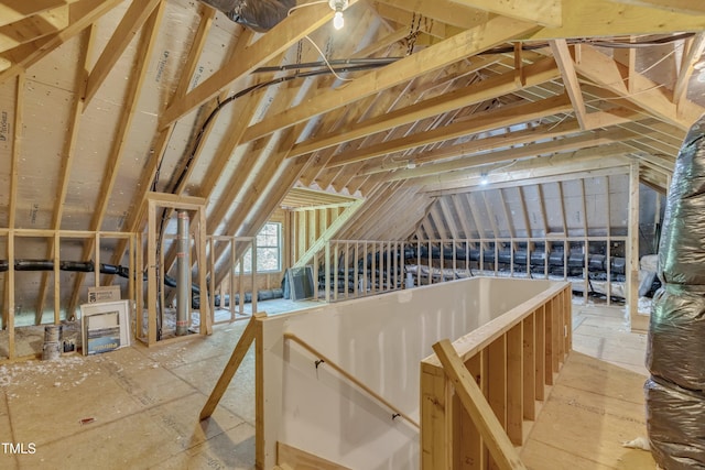 unfinished attic with an upstairs landing