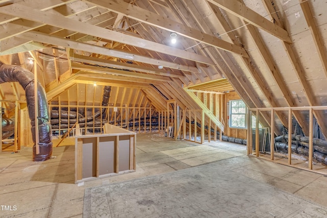 unfinished attic with an upstairs landing