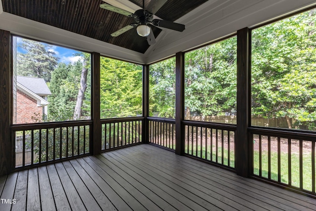 unfurnished sunroom featuring a ceiling fan