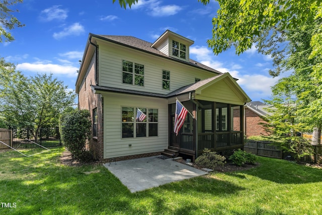back of property featuring a lawn, a patio, a fenced backyard, and a sunroom