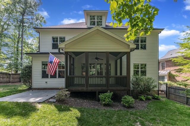 back of house with fence private yard, ceiling fan, a sunroom, a gate, and a yard