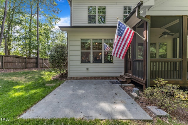 exterior space featuring a lawn, fence, a ceiling fan, and a patio area