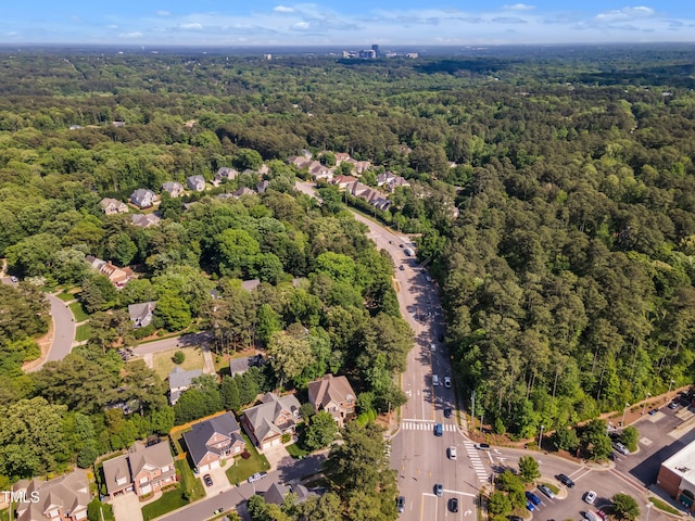 drone / aerial view with a residential view and a view of trees
