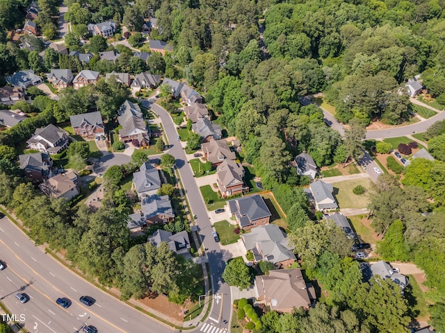 drone / aerial view with a residential view and a view of trees