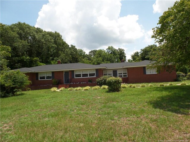 6019 S US Highway 301, Hope Mills, NC 28348 - ranch-style house featuring a chimney, a front yard, and brick siding