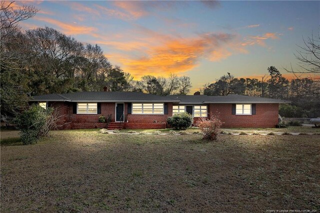 6019 S US Highway 301, Hope Mills, NC 28348 - view of front of house with a chimney, a front lawn, and brick siding