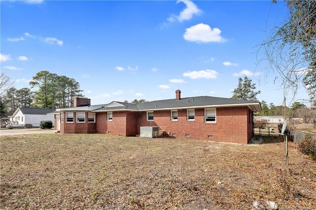 6019 S US Highway 301, Hope Mills, NC 28348 - rear view of property with crawl space, a chimney, brick siding, fence, and concrete driveway