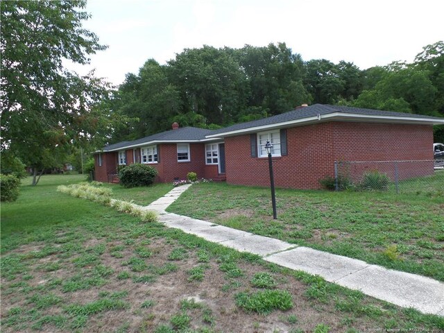 6019 S US Highway 301, Hope Mills, NC 28348 - exterior space featuring fence, a front lawn, and brick siding