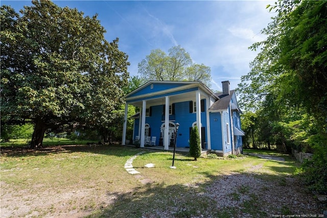 236 E Andrews Ave, Henderson, NC 27536 - back of property featuring covered porch, a yard, and a chimney