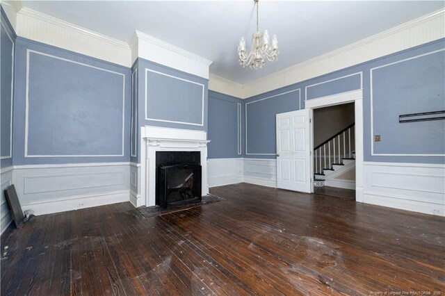 236 E Andrews Ave, Henderson, NC 27536 - unfurnished living room with stairs, a notable chandelier, and a decorative wall