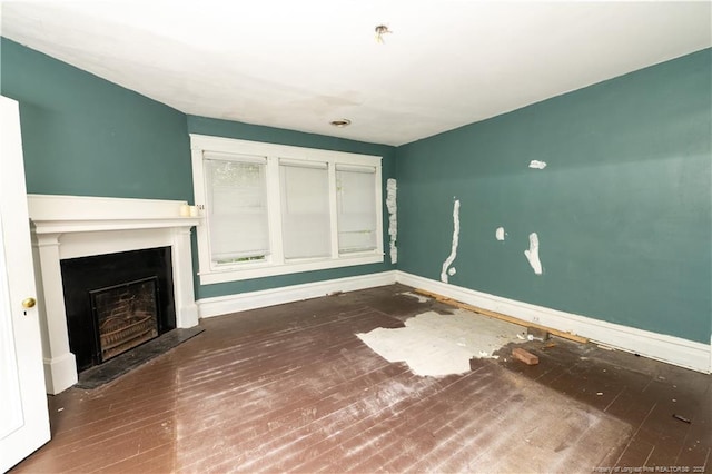 236 E Andrews Ave, Henderson, NC 27536 - unfurnished living room with baseboards, hardwood / wood-style floors, and a fireplace