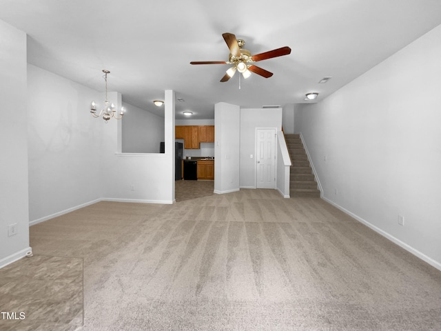 unfurnished living room with baseboards, light carpet, stairway, and ceiling fan with notable chandelier