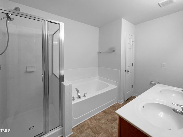 bathroom with visible vents, a sink, a bath, and a shower stall