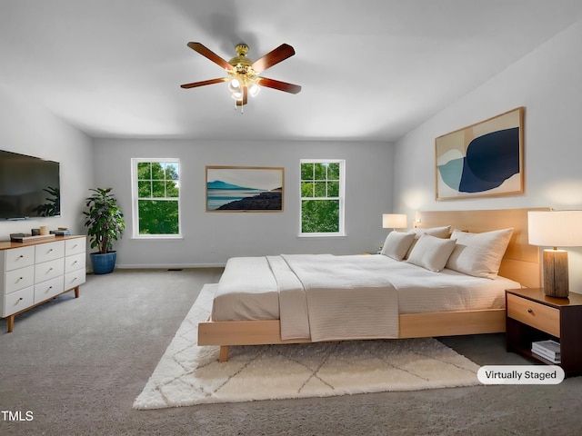 carpeted bedroom featuring baseboards and ceiling fan