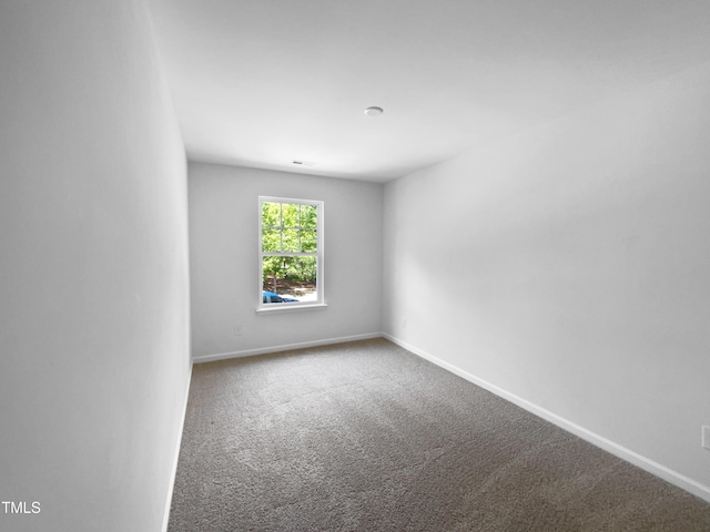 carpeted empty room with baseboards