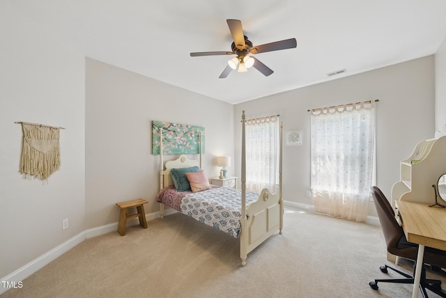 bedroom with visible vents, baseboards, ceiling fan, and light carpet