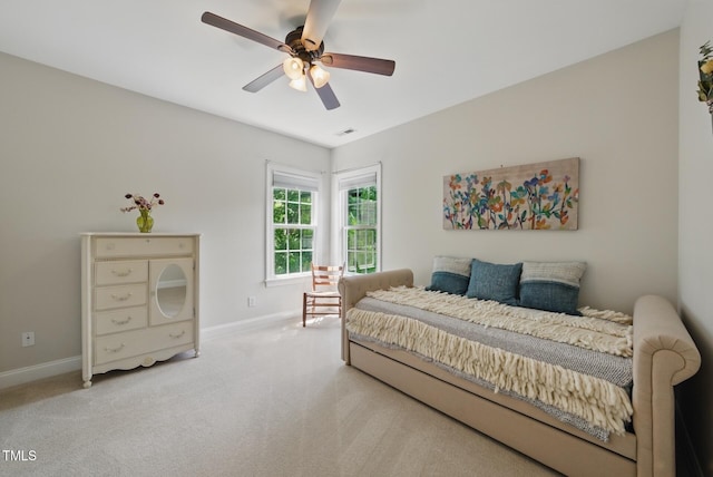 carpeted bedroom with baseboards, visible vents, and ceiling fan