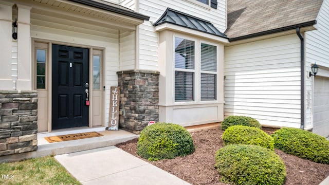 912 Beech Glen Dr, Mebane, NC 27302 - property entrance featuring roof with shingles, a standing seam roof, metal roof, and stone siding