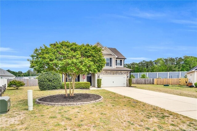 view of front of property with concrete driveway, a garage, fence, and a front lawn