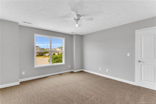 empty room with baseboards, carpet flooring, and visible vents