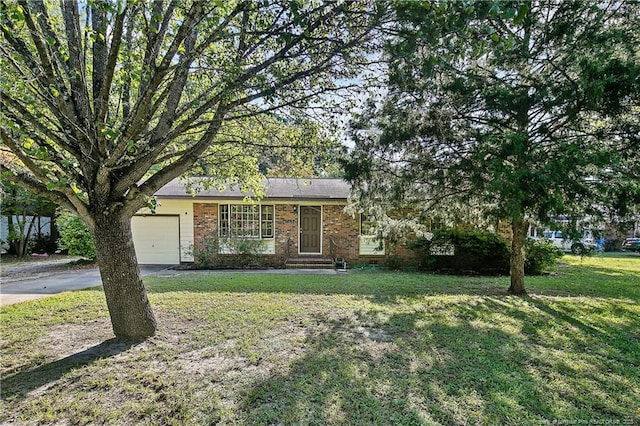 1001 Arberdale, Fayetteville, NC 28304 - view of front of property featuring brick siding, a front lawn, an attached garage, and driveway