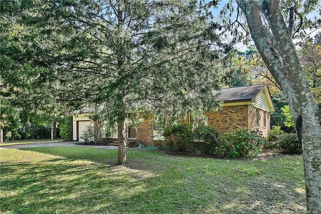 1001 Arberdale, Fayetteville, NC 28304 - view of front facade featuring brick siding, a front yard, and a garage