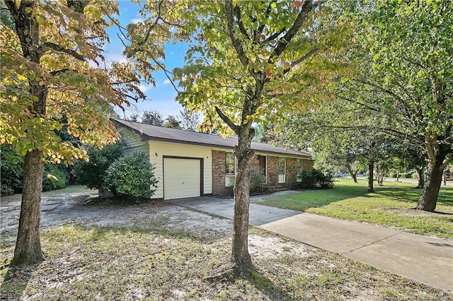 1001 Arberdale, Fayetteville, NC 28304 - view of front of home featuring an attached garage, concrete driveway, a front lawn, and brick siding