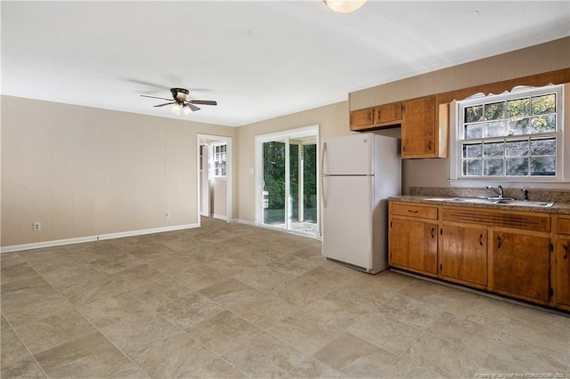 1001 Arberdale, Fayetteville, NC 28304 - kitchen featuring a sink, freestanding refrigerator, a ceiling fan, and brown cabinets