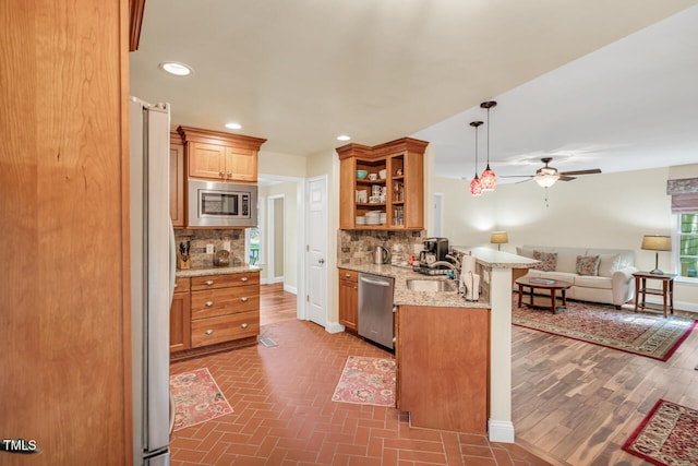 11 Bridgeport Dr, Durham, NC 27713 - kitchen with decorative backsplash, open shelves, a peninsula, open floor plan, and stainless steel appliances