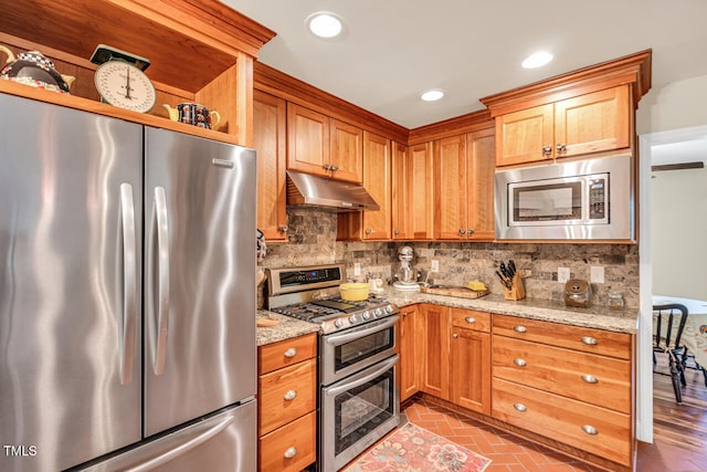 11 Bridgeport Dr, Durham, NC 27713 - kitchen featuring light stone countertops, appliances with stainless steel finishes, recessed lighting, tasteful backsplash, and under cabinet range hood