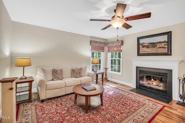 11 Bridgeport Dr, Durham, NC 27713 - living area with baseboards, ceiling fan, a fireplace with flush hearth, and wood finished floors