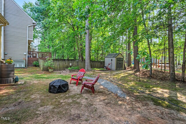 11 Bridgeport Dr, Durham, NC 27713 - view of yard with a wooden deck, fence, a shed, an outdoor fire pit, and an outbuilding