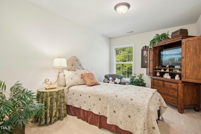 bedroom with light colored carpet and visible vents