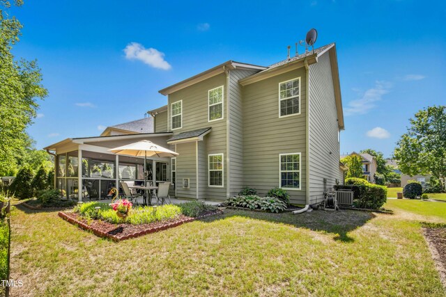 back of property with a lawn, a patio area, and central air condition unit