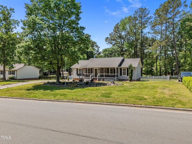 view of front of home with fence and a front yard