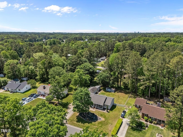 bird's eye view with a wooded view