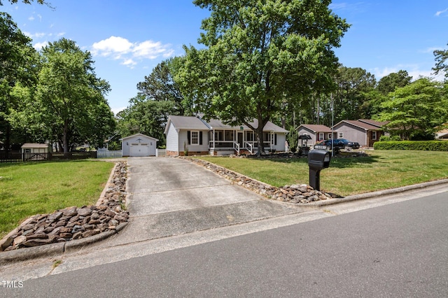 ranch-style house featuring fence, a front lawn, a detached garage, concrete driveway, and an outdoor structure