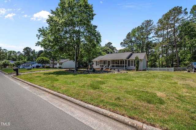 view of front facade with fence and a front yard