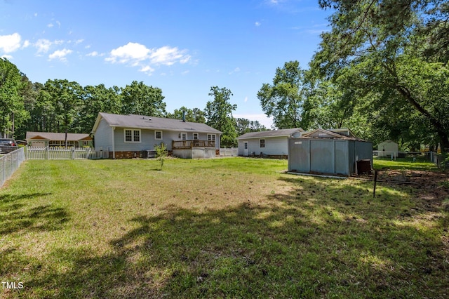 view of yard with an outdoor structure and a fenced backyard